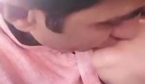 Pakistani couple business and giving a kiss in car
