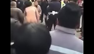 Chinese woman amass off pillar not tell who's who of pants fighting with cops